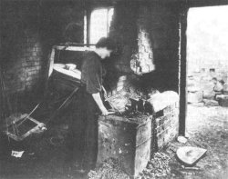 Photo of a woman working at a hearth - from Roy Palmer's postcard collection.