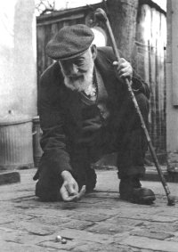 George 'Pop' Maynard playing marbles at Tinsley Green. Photo by John Jackson