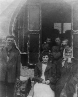 Mikeen McCarthy with family and friends with the caravan he built and painted, c. late 1950s.