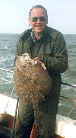 Keith Summers (pictured with the biggest fish he ever caught: a 17½ pound skate.  Photo by John Howson, I think) off Felixstowe, 1997.
